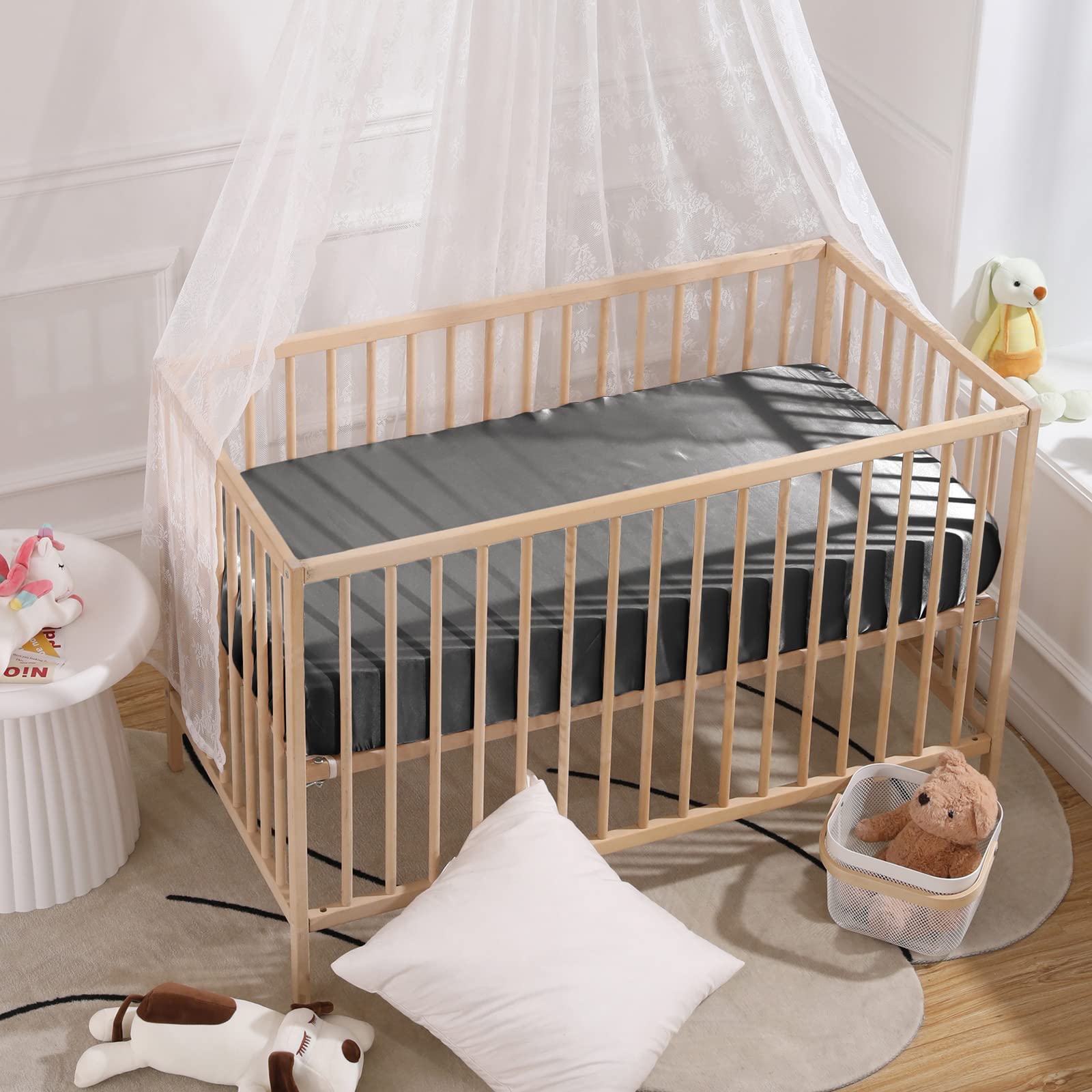 Two-color satin sheets fit widely used pack n play setups for versatile use.
