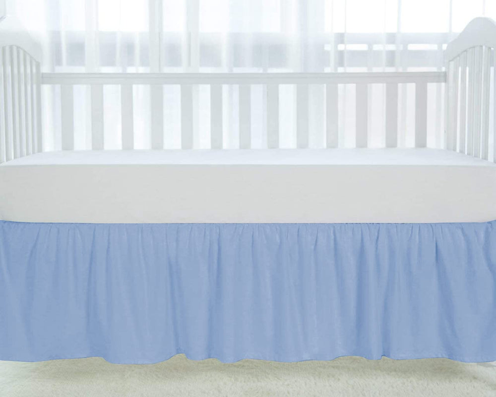 Silentnight light blue crib skirt shows elegant ruffles around the crib posts.