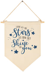 Sioial Look At The Stars banner hanging above crib for cozy nursery decor.