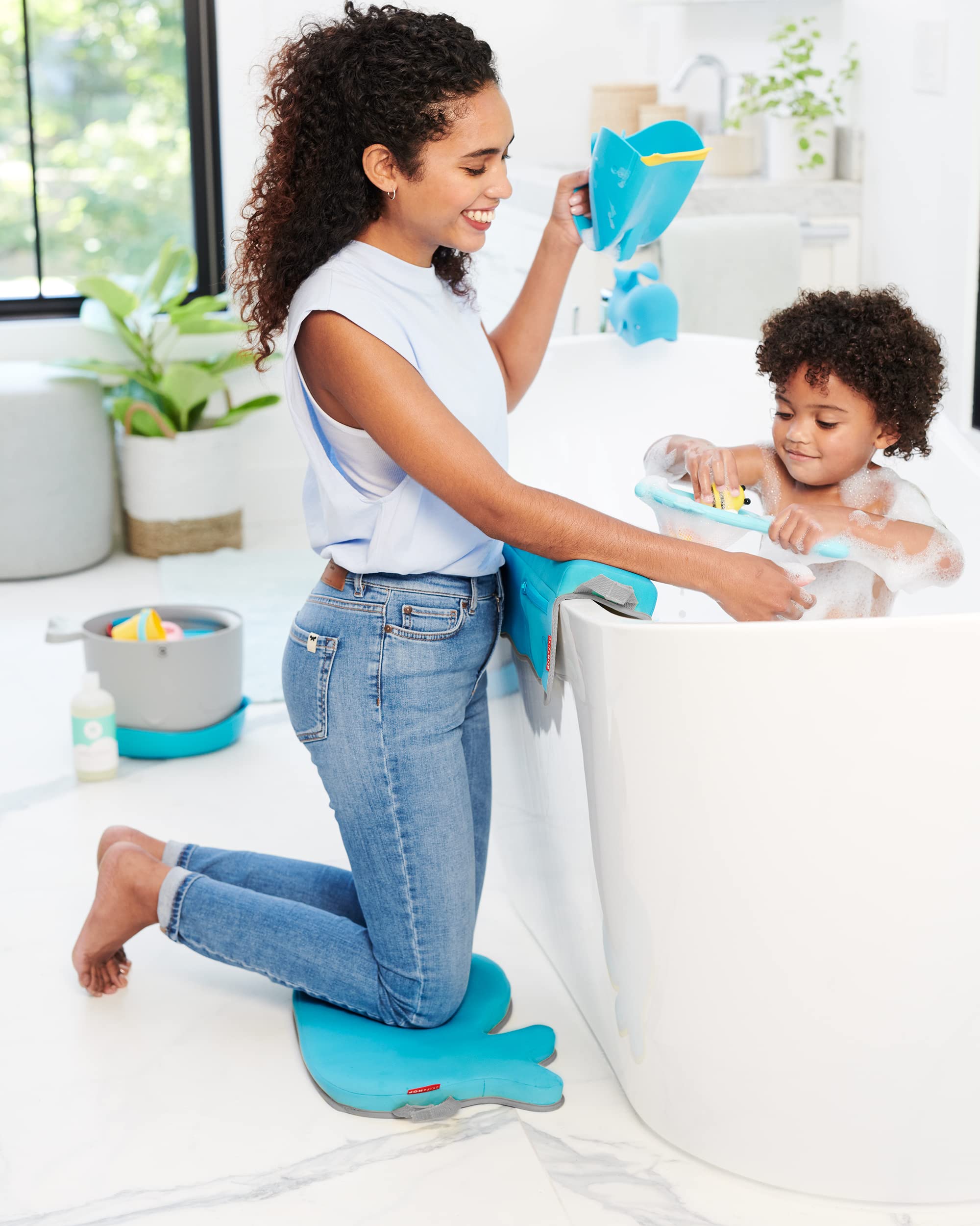 Skip Hop MOBY rinse cup hangs to dry after baths in blue