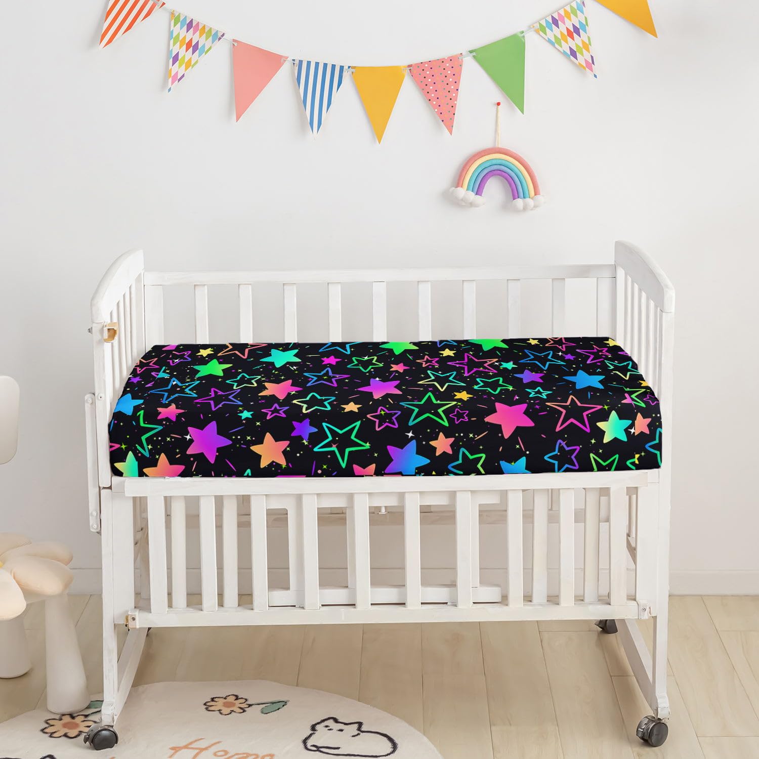 Smell Sunshine crib skirt coordinates with colorful gradient stars for a cohesive look.