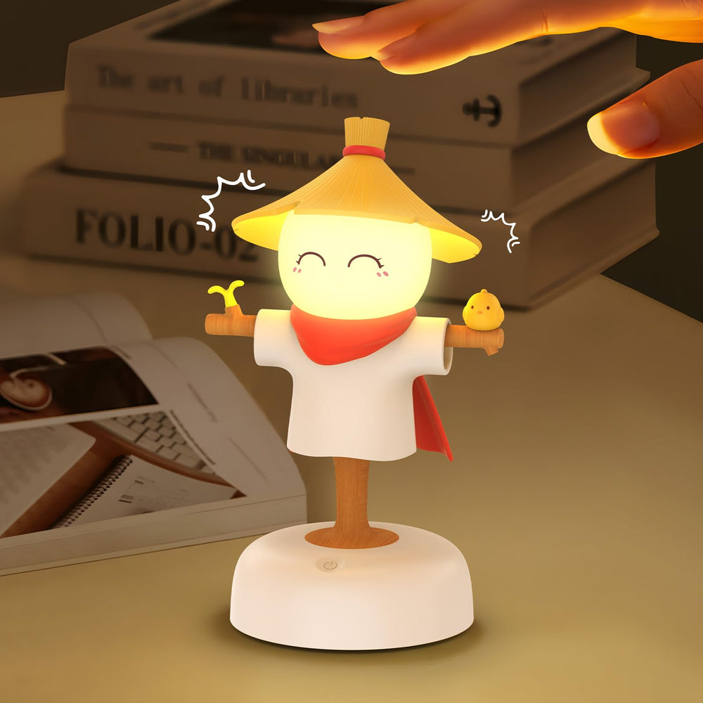 Smiling Shark scarecrow night light glows amber for a cozy nursery ambiance