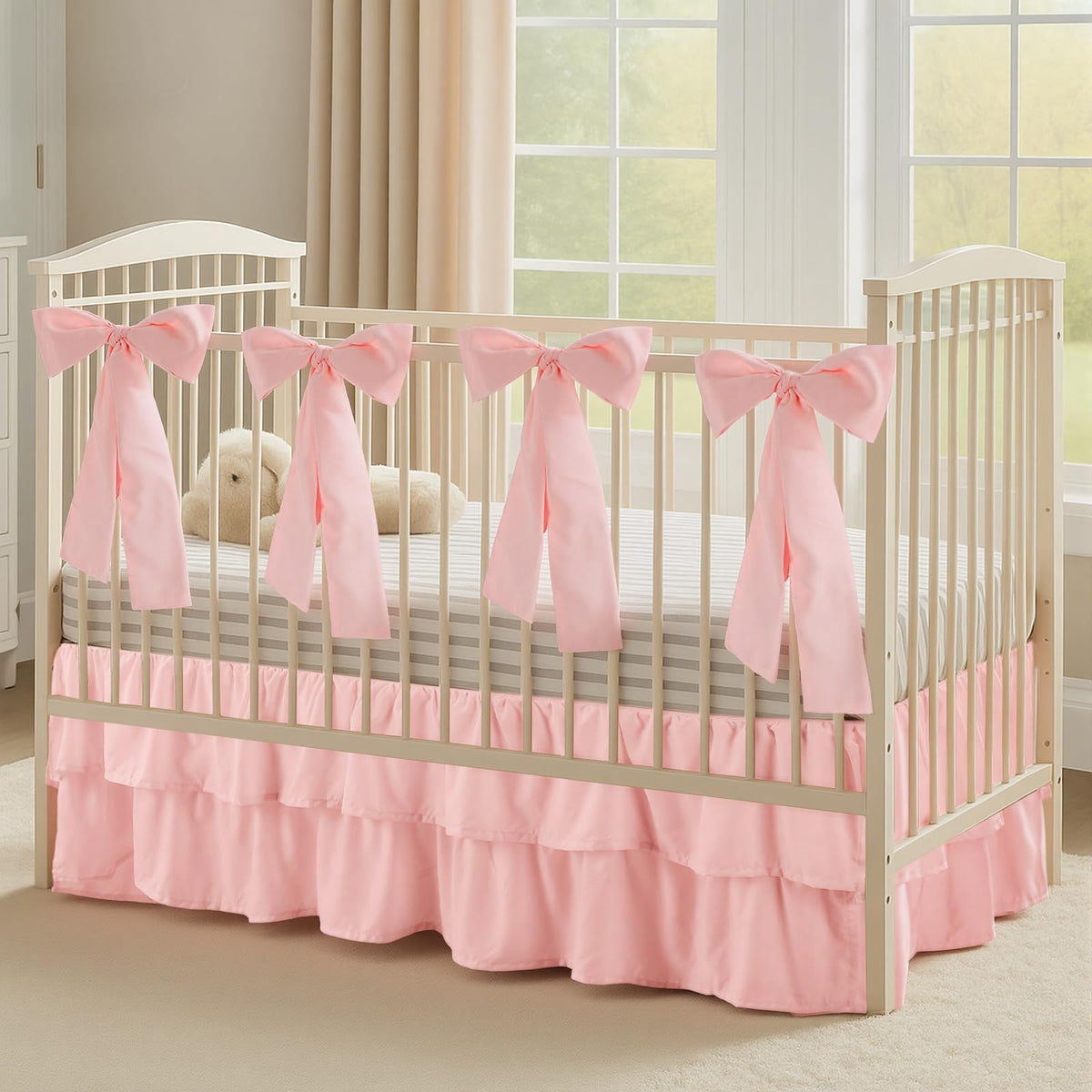 SmoothNovelty Pink crib skirt with bows enhances nursery decor and secure accents