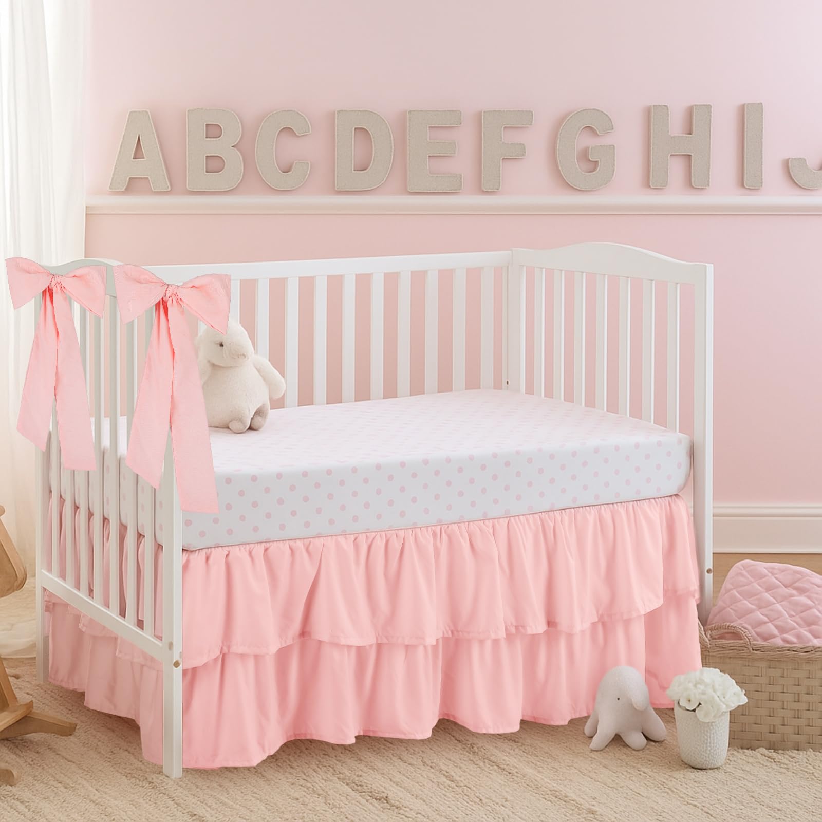 SmoothNovelty Pink crib skirt with hidden straps to stay aligned