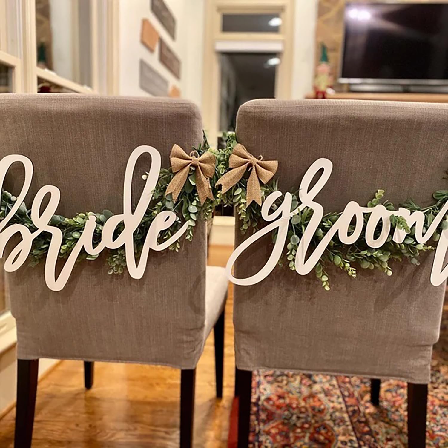 Snlioek bride and groom signage unifies chairs with table settings.
