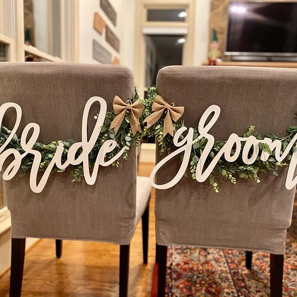 Snlioek bride and groom signage unifies chairs with table settings.