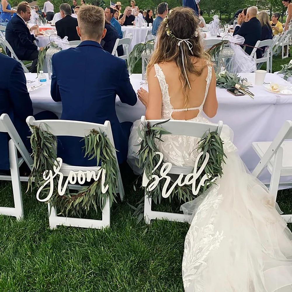Snlioek vintage chair sign elevates rustic wedding decor.