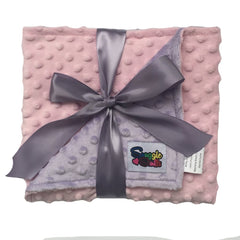 Snuggle Stuffs reversible minky dot blanket in pink and lavender provides cozy warmth for crib and stroller.