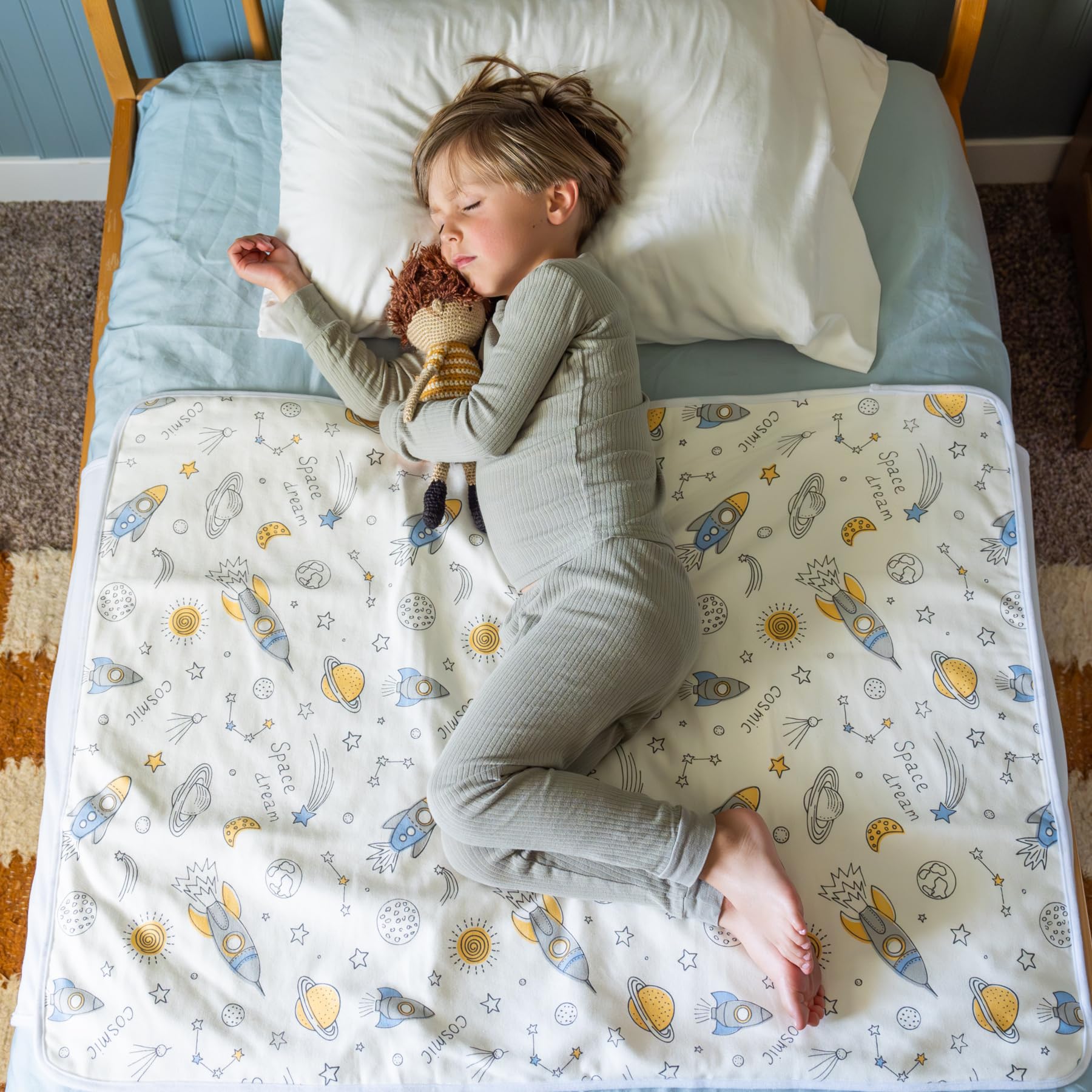 Snugglekid tuckable side bed wetting pad with side flaps keeps pad in place for mess-free use.