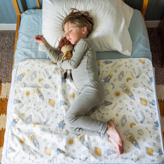 Snugglekid tuckable side bed wetting pad with side flaps keeps pad in place for mess-free use.