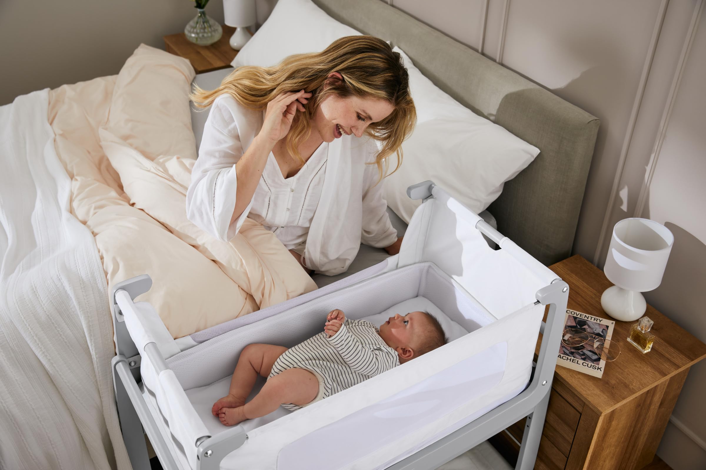 Lift-off crib feature demonstrated for easy transport and nearby baby access.