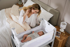 Lift-off crib feature demonstrated for easy transport and nearby baby access.