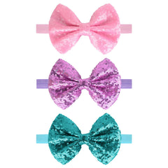 Song Qing sequined bow hair band for infant girls with soft cotton comfort.