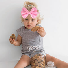 Song Qing infant turban knot headband with stretchy nylon band for easy wear.
