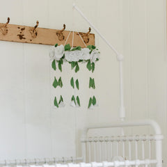 Sorrel and Fern anti-slip pad detail protects crib finish while keeping mobiles steady.