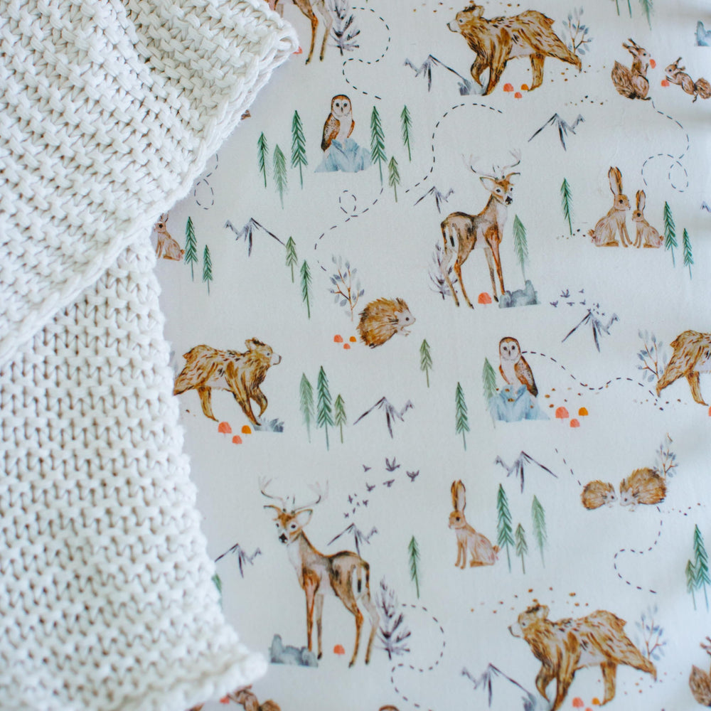 Sorrel + Fern bassinet sheets in use create a tidy, snug sleep space.