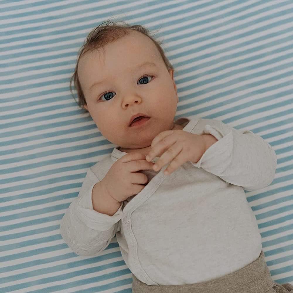 Sorrel + Fern deep-pocket elastic edge prevents slipping on changing pad.