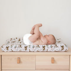 Sorrel + Fern Magic Forest cover in use with baby during diaper change.