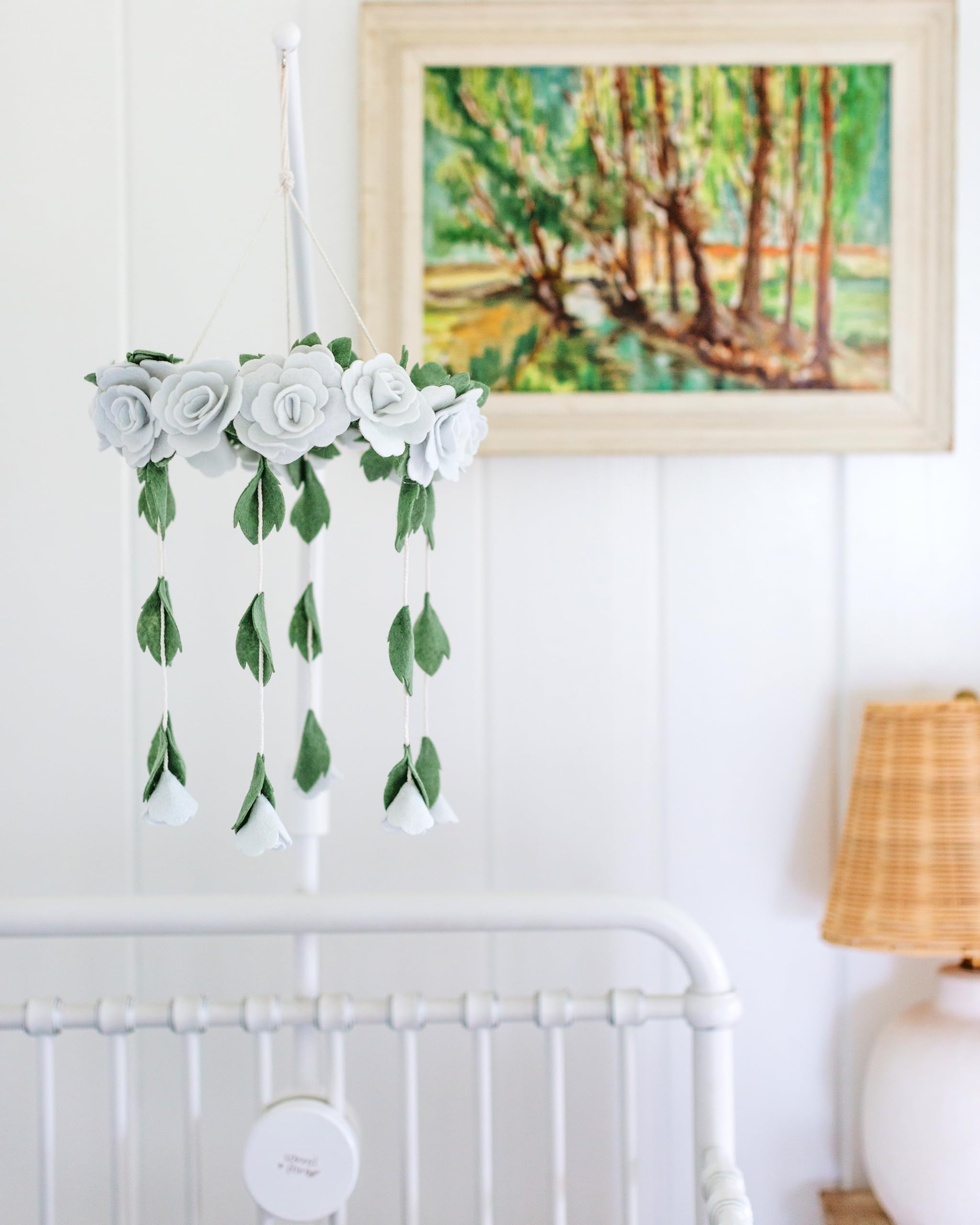 Sorrel and Fern 31-inch arm shown mounted with crib for easy mobile hanging and use.