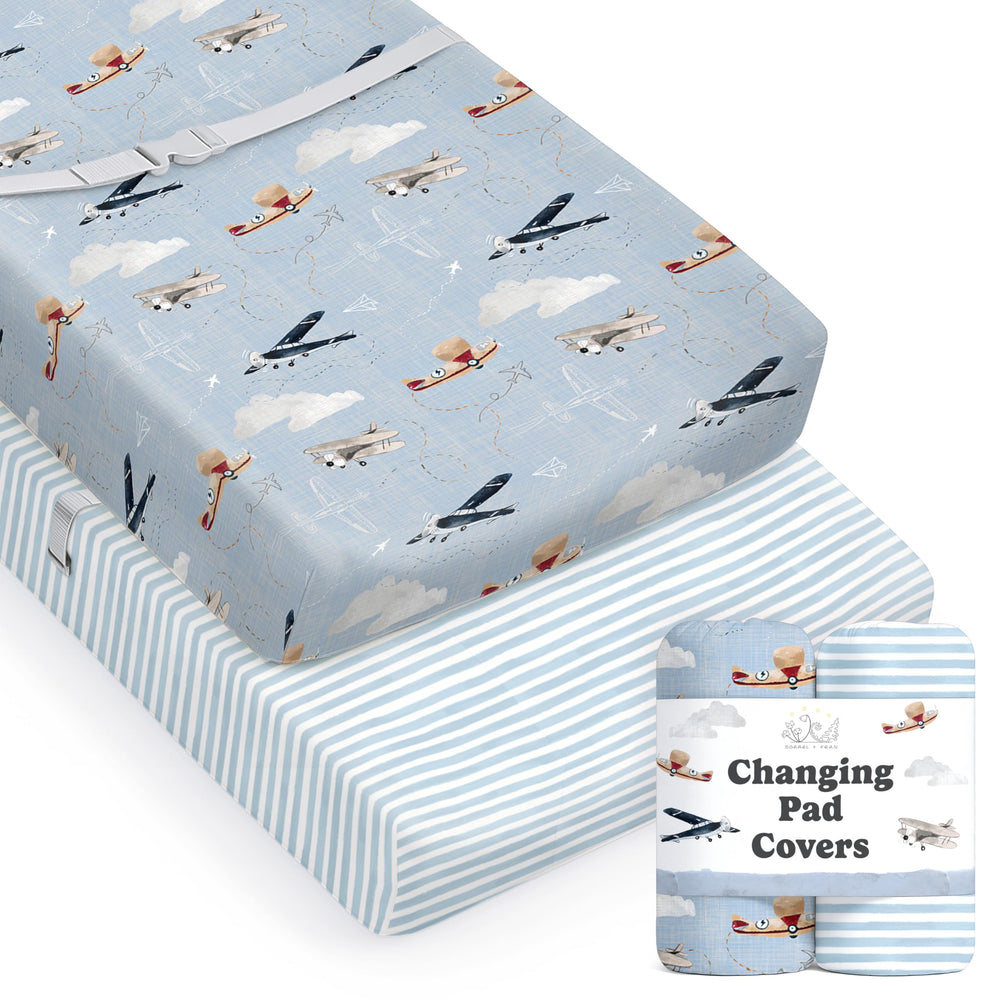 Sorrel + Fern watercolor airplanes changing pad cover on a soft baby surface.
