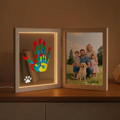 Sortnic family handprint frame with light displaying four prints and a photo for nursery warmth.