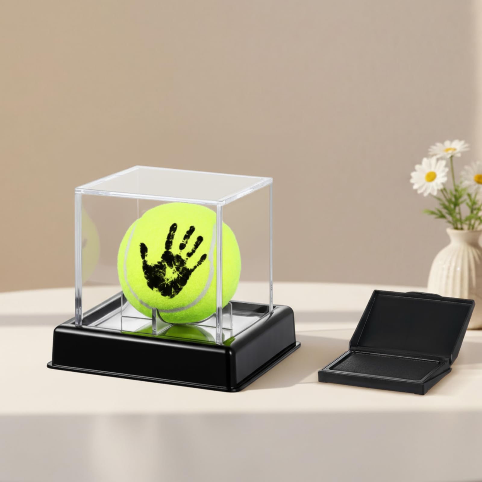 Soulchen baby tennis ball handprint kit showing a printed hand on the keepsake ball