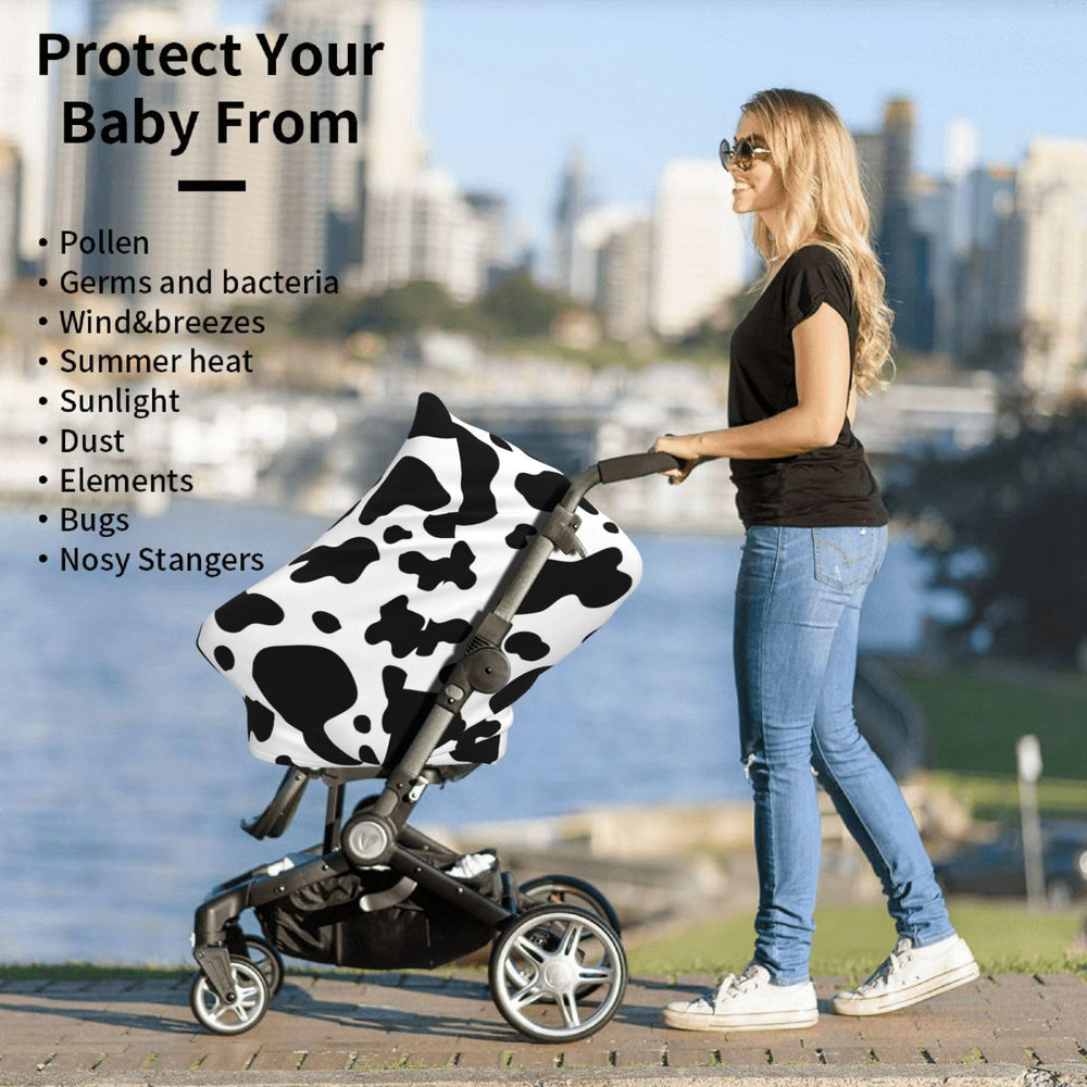 Sozzjile cow print stroller cover doubles as a nursing shield.