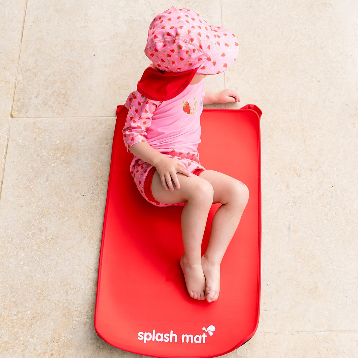 Splash About Baby Neoprene Changing Mat Red on bedside table for quick changes