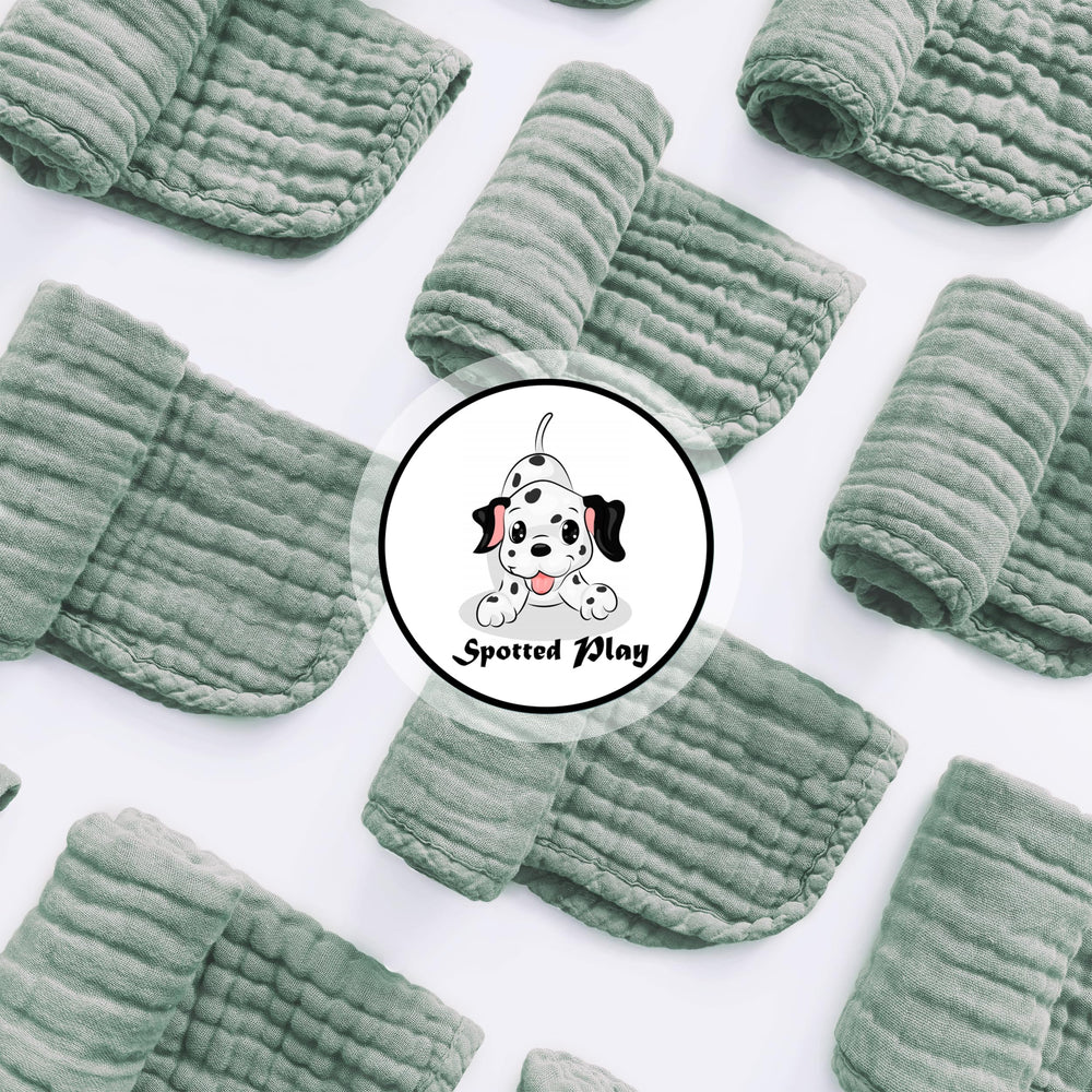 Spotted Play muslin cotton burp cloths pack of 12 laid flat for versatility.