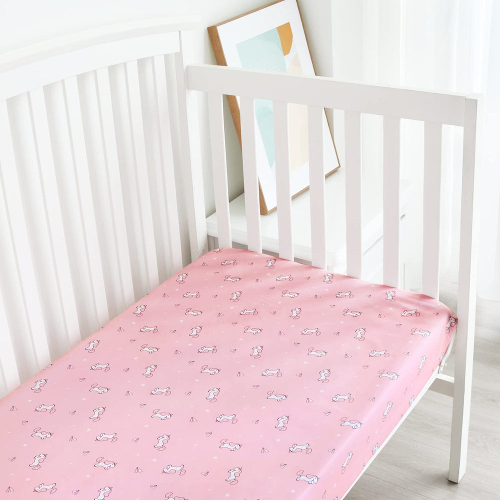 SPRINGSPIRIT girl crib sheets adds soft, neutral and pink tones to nursery decor.