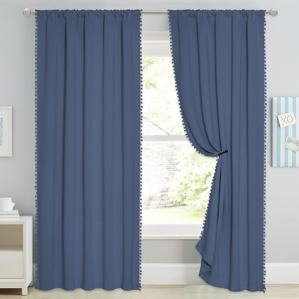 StangH pom-pom trim close-up on stone blue curtains.