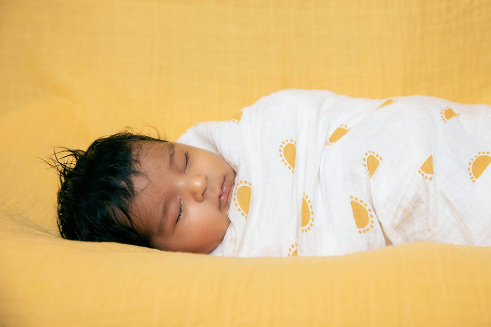 Sticky Toffee Muslin Swaddle 47x47 laid flat showing generous size.