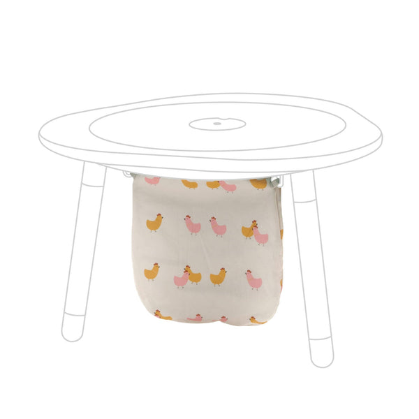 Stokke MuTable Cotton Bag with Chicks pattern attached to hooks for tidy toy storage.