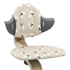 Stokke Nomi Mickey Signature cushion attached to chair for extra comfort