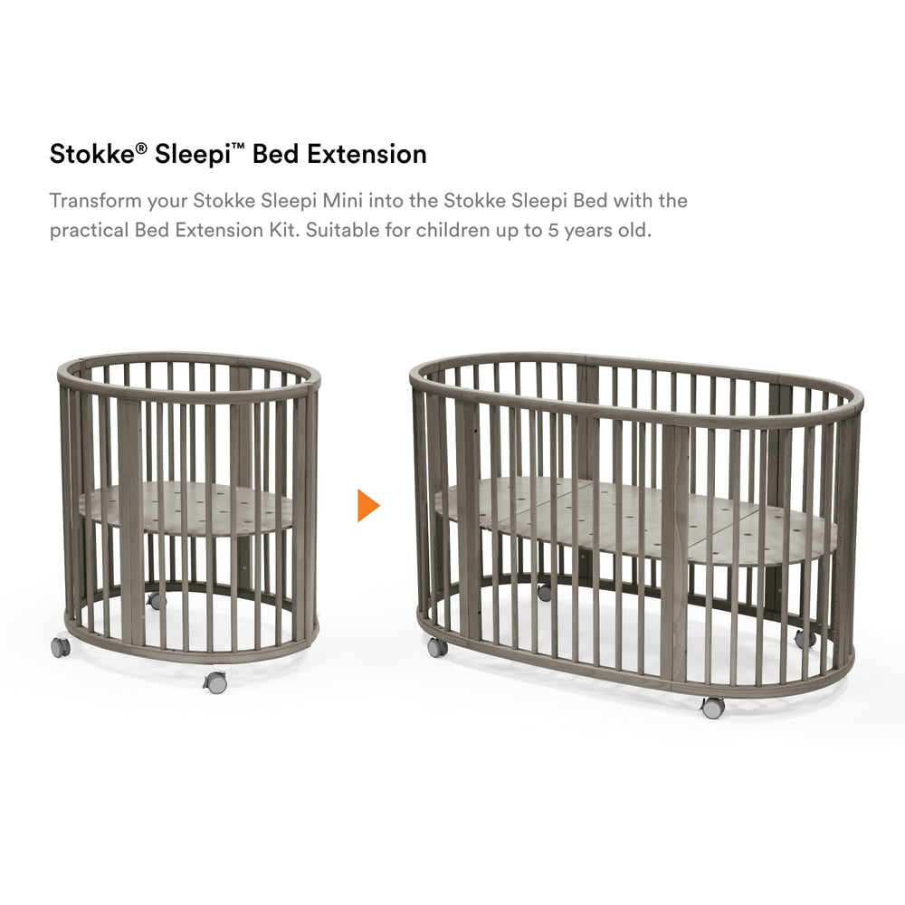 Stokke Sleepi Bed Extension V3 hazy grey in use, converting a mini crib to a full bed.