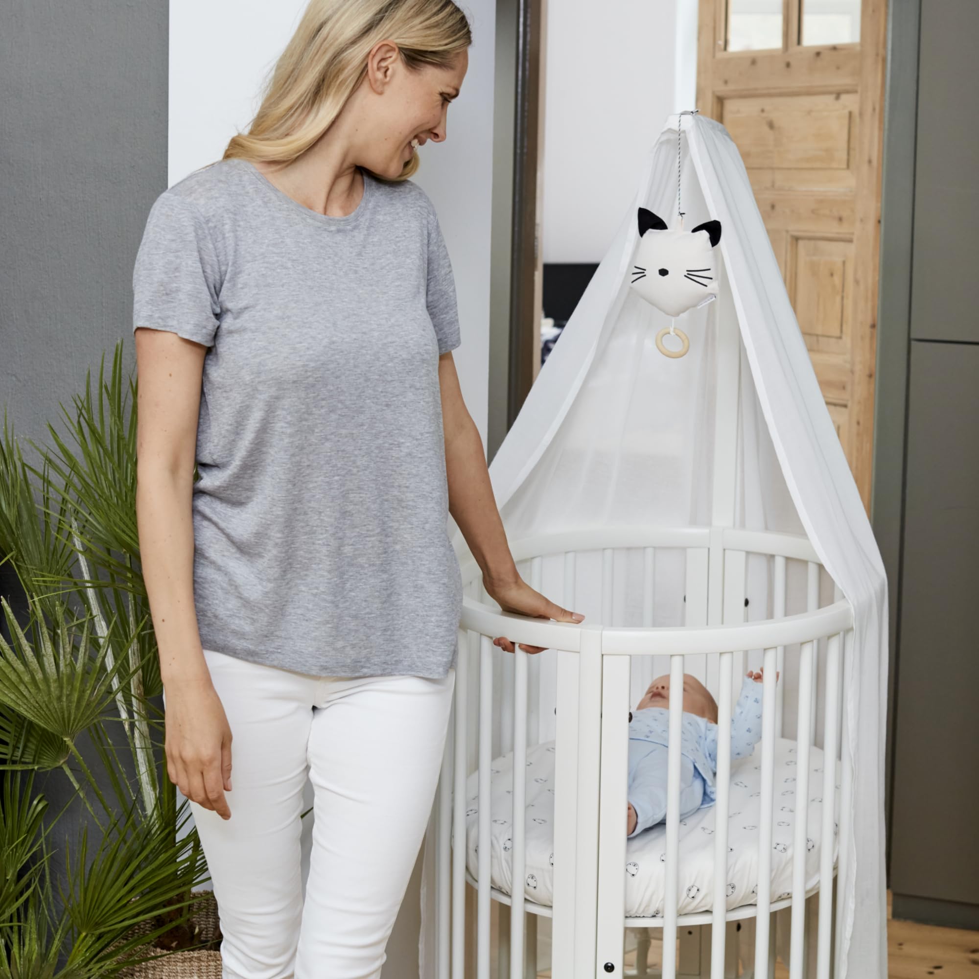 Stokke Sleepi Drape Rod with curtain demonstrates versatile nursery styling options.
