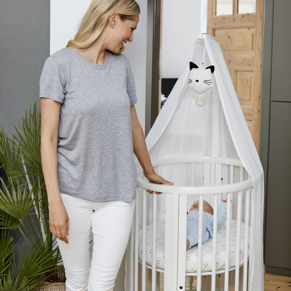 Stokke Sleepi Drape Rod with curtain demonstrates versatile nursery styling options.