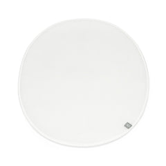 Stokke Sleepi Mini Protection Sheet V3 in white on bed, keeping the sleep surface clean.