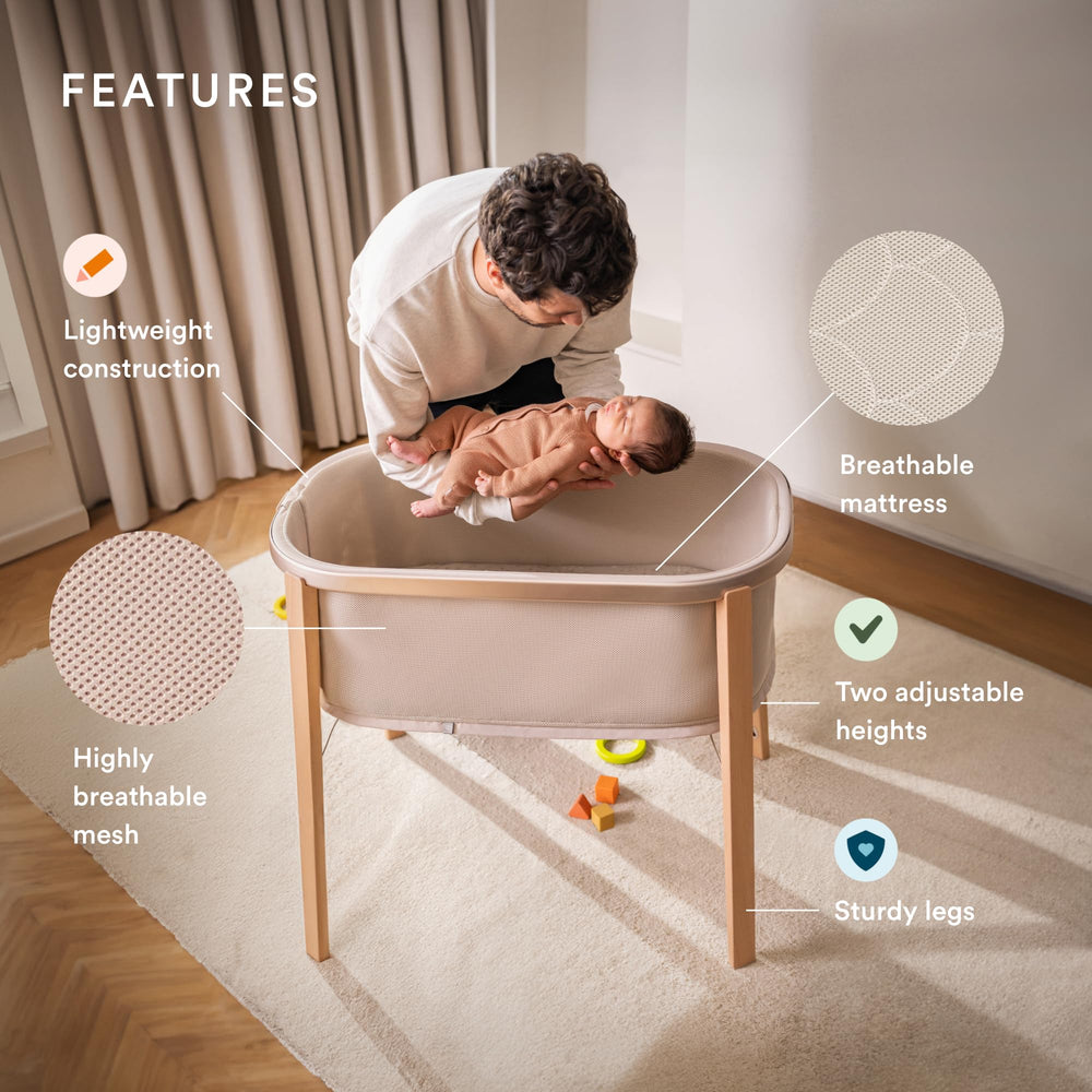 Stokke Snoozi Bassinet side view highlights height adjustment for growing babies.