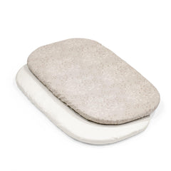 Stokke Snoozi fitted sheet on oval mattress with wraparound zipper for secure fit