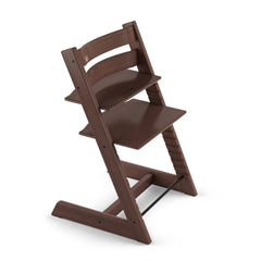 Stokke Tripp Trapp chair in walnut finish ready for family dining, showcasing the visual elegance and versatility