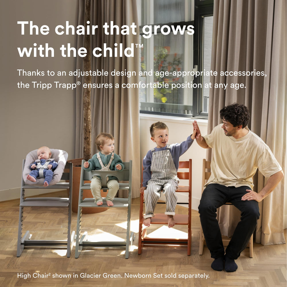 Stokke Tripp Trapp Oak High Chair 2 with Baby Set attached for toddlers.