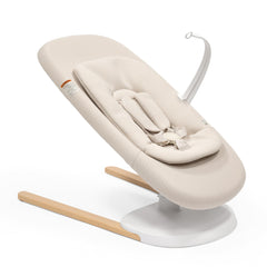 Stokke Yoga baby bouncer and swing in light sand offers soothing dual motion.