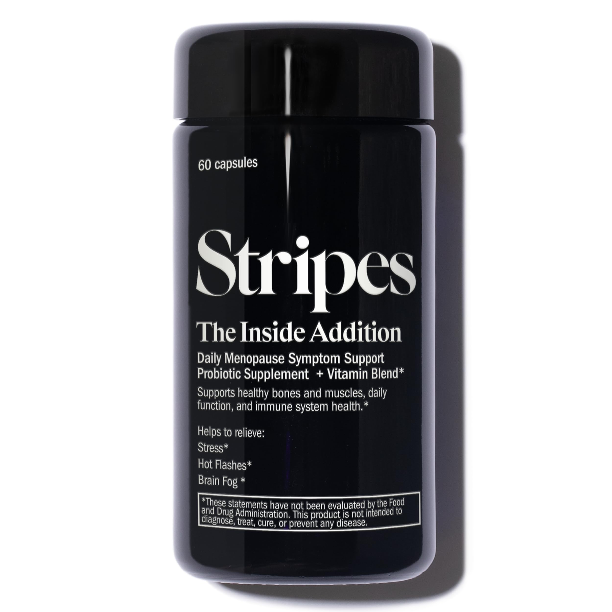 Stripes Beauty Naomi Watts Addition bottle on desk for daily probiotic support and wellness.