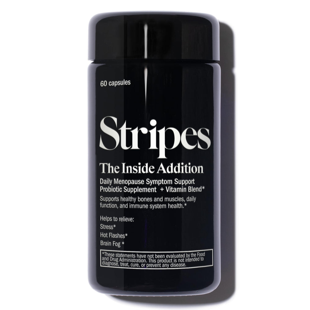 Stripes Beauty Naomi Watts Addition bottle on desk for daily probiotic support and wellness.