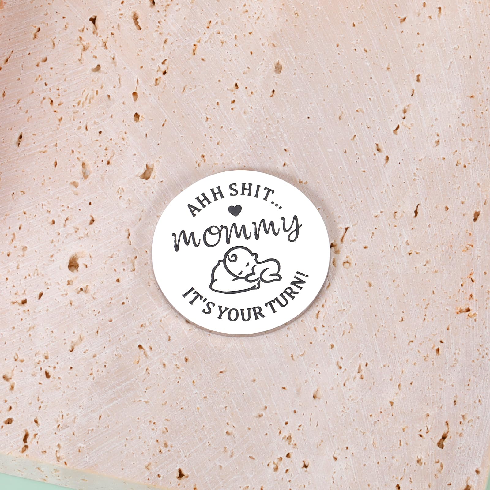 Closeup of STVK coin engraving on Mommy's Turn for balanced parenting choices