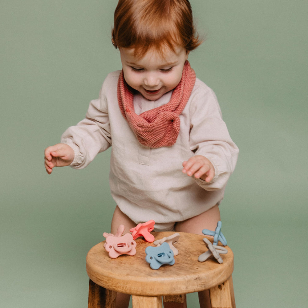Holder capable of fitting two pacifiers for organized travel.