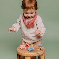 Holder capable of fitting two pacifiers for organized travel.