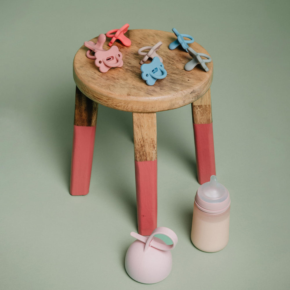 Compact blue pacifier holder keeps pacifiers clean and accessible.