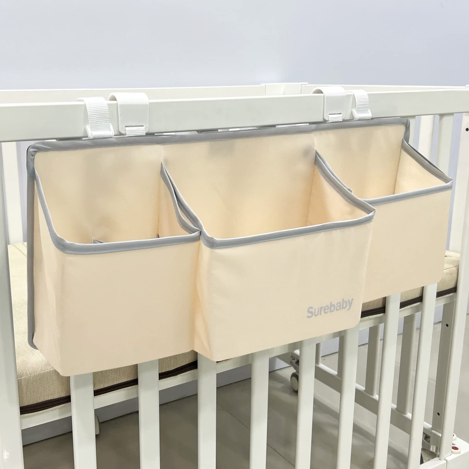 Surebaby hanging diaper caddy on crib rail keeps baby essentials within reach